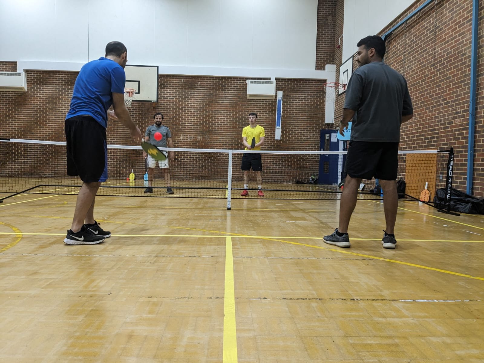 Four players at Lemon Pickleball working on their dink shot and punch volley in North London