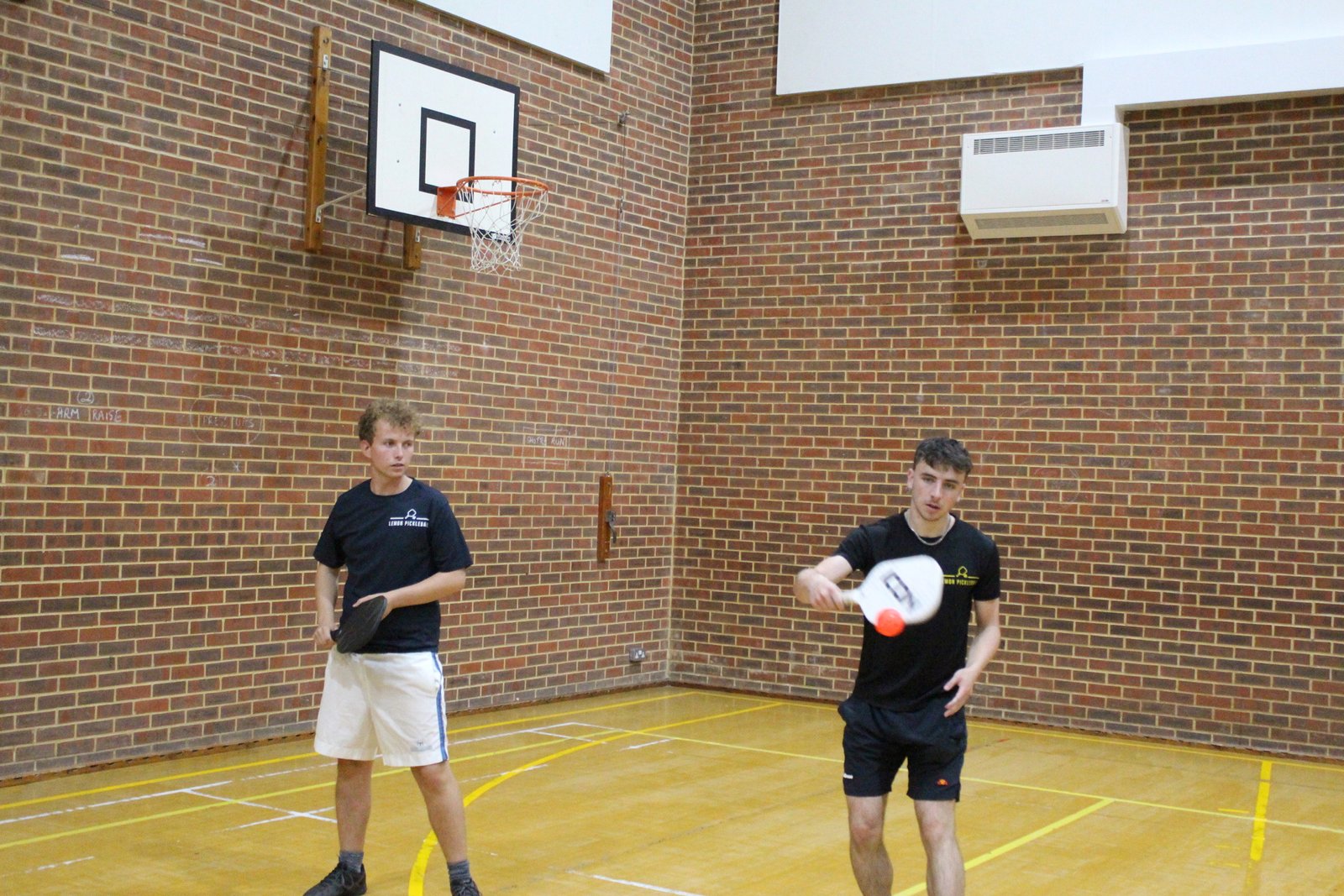 Alex playing pickleball in Finchley, hitting a backhand volley