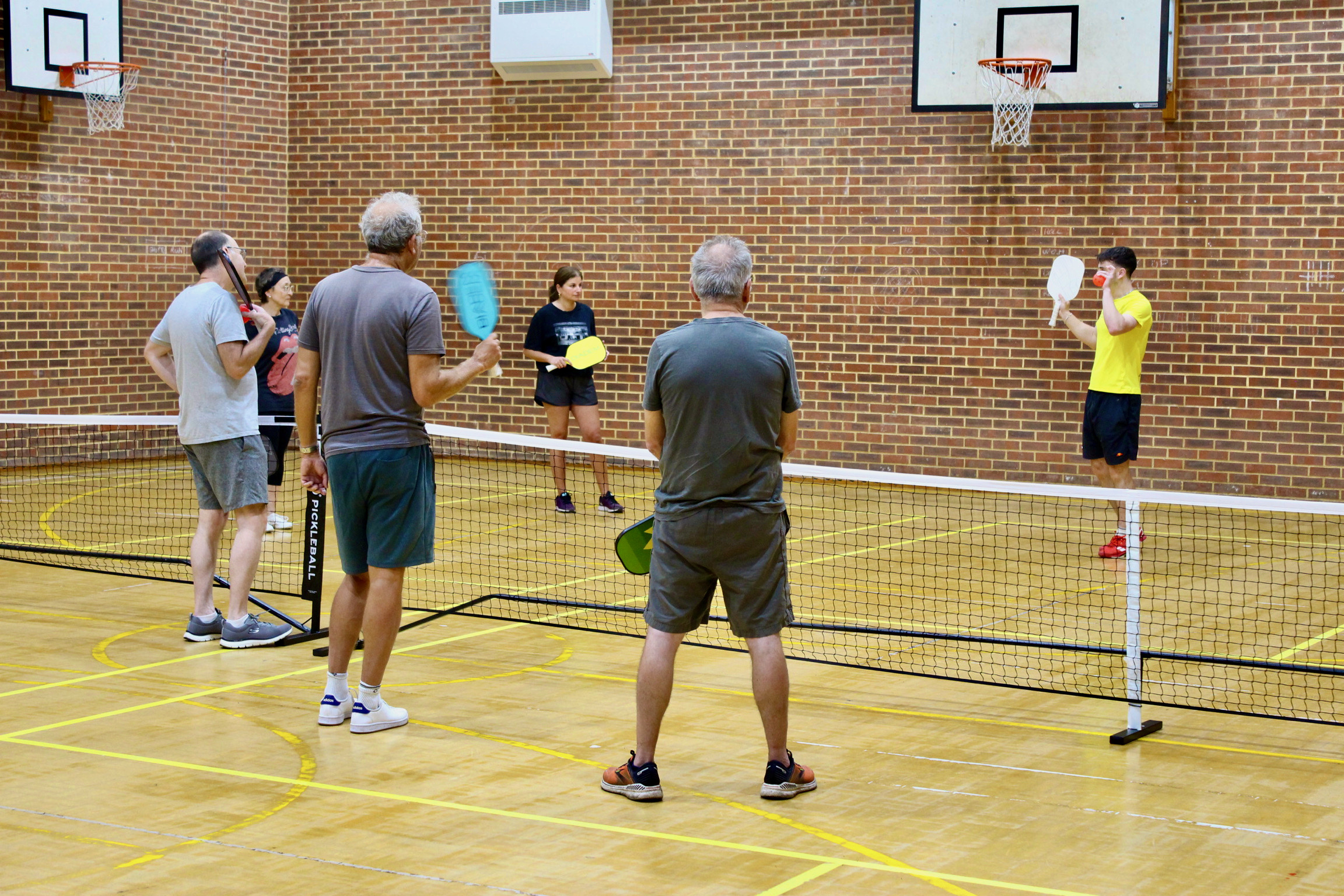 A coach leading a small-group pickleball lesson