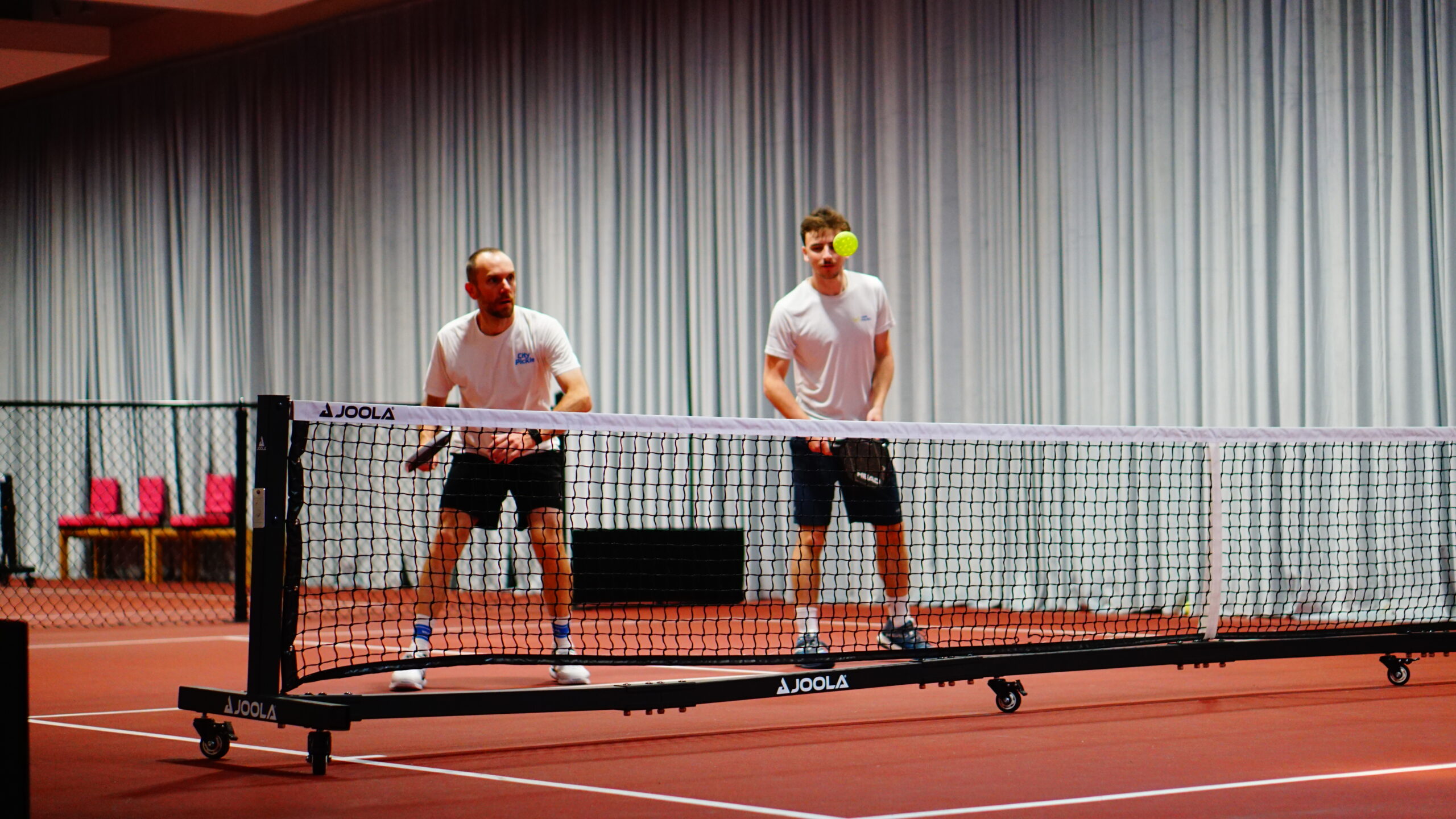 Advanced players in a fast pickleball rally